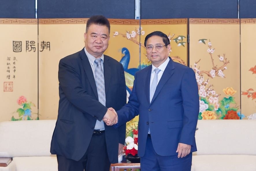 Phiên bản chính thức của 555Win Phạm Minh Chính tiếp ông Tào Vinh Căn, Chủ tịch Công ty TNHH Trung tâm 555win phien bạn Chính Thức và Đấu giá Hoa Quốc tế Côn Minh - Ảnh: VGP