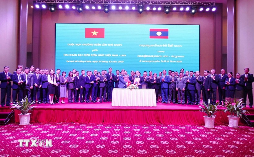 Trưởng đoàn Đại biểu biên giới hai nước Việt Nam-Lào trao đổi biên bản ký kết. Ảnh: TTXVN.