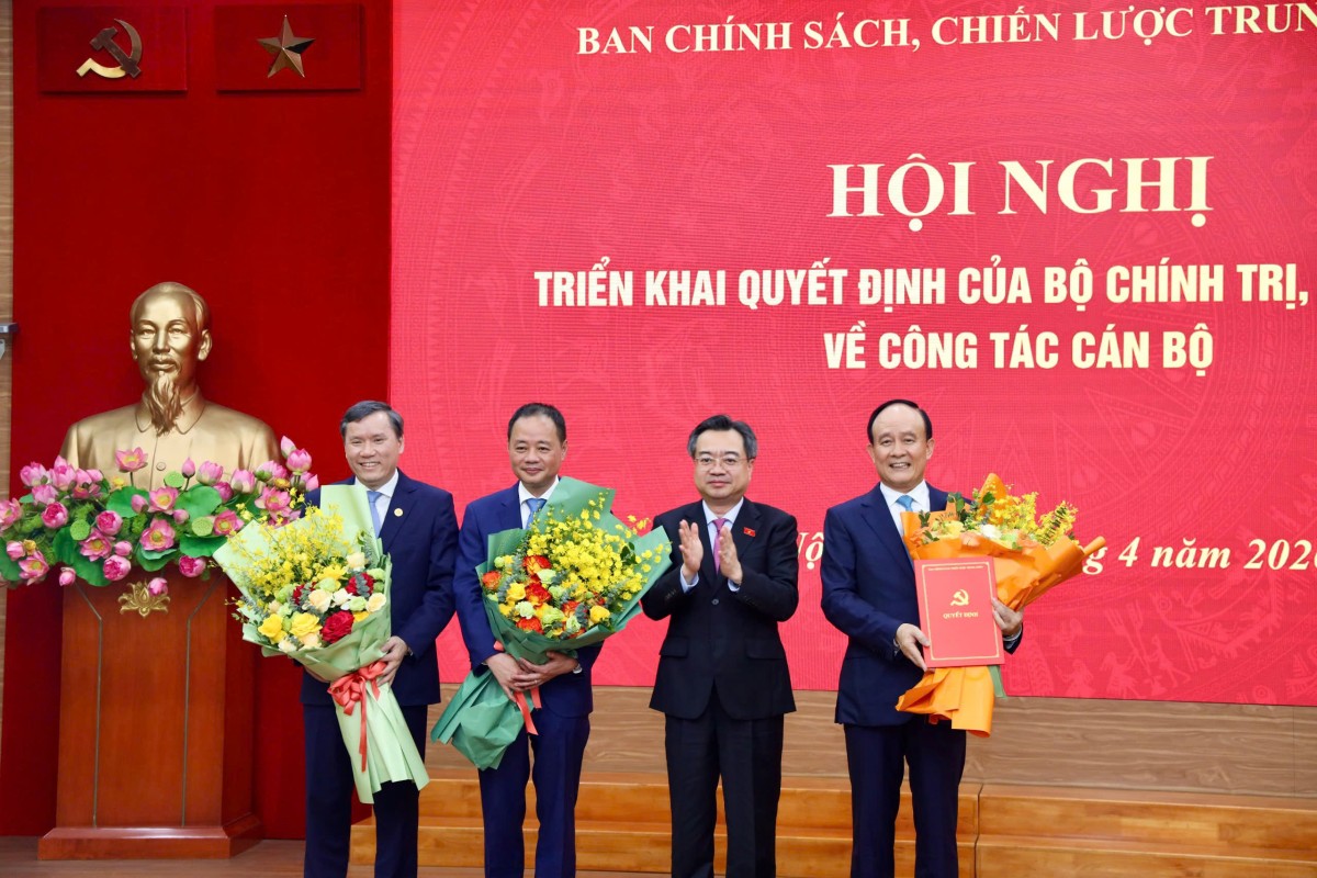 Trưởng ban Chính sách, chiến lược Trung ương Nguyễn Thanh Nghị tặng hoa 3 tân Phó trưởng ban. Ảnh: