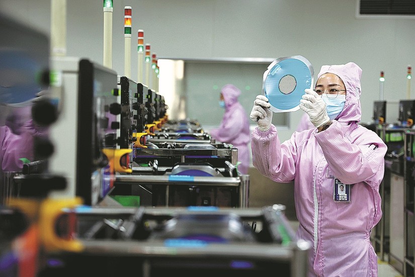 Một nh&acirc;n vi&ecirc;n l&agrave;m việc trong một nh&agrave; m&aacute;y sản xuất chất b&aacute;n dẫn ở T&acirc;n Ch&acirc;u, tỉnh Sơn Đ&ocirc;ng.