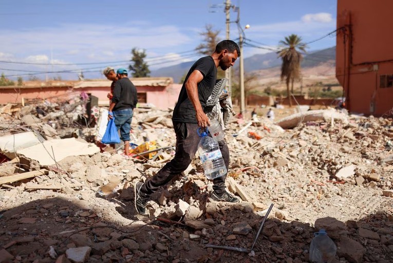 Người d&acirc;n Amizmiz, Morocco t&igrave;m kiếm trong đống đổ n&aacute;t sau trận động đất. Ảnh: Reuters